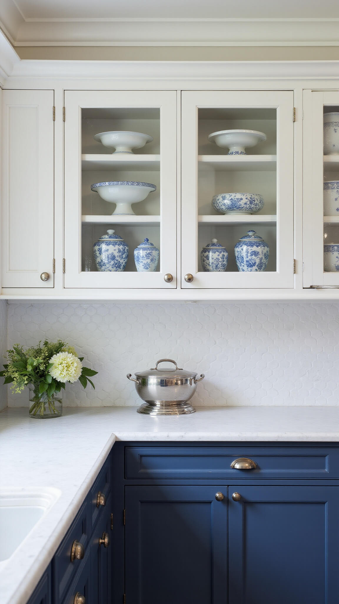 Classic 12x14ft kitchen with navy beadboard cabinets, white marble countertops, penny tile backsplash, and glass-front uppers displaying china, styled with blue-and-white decor in soft morning light.