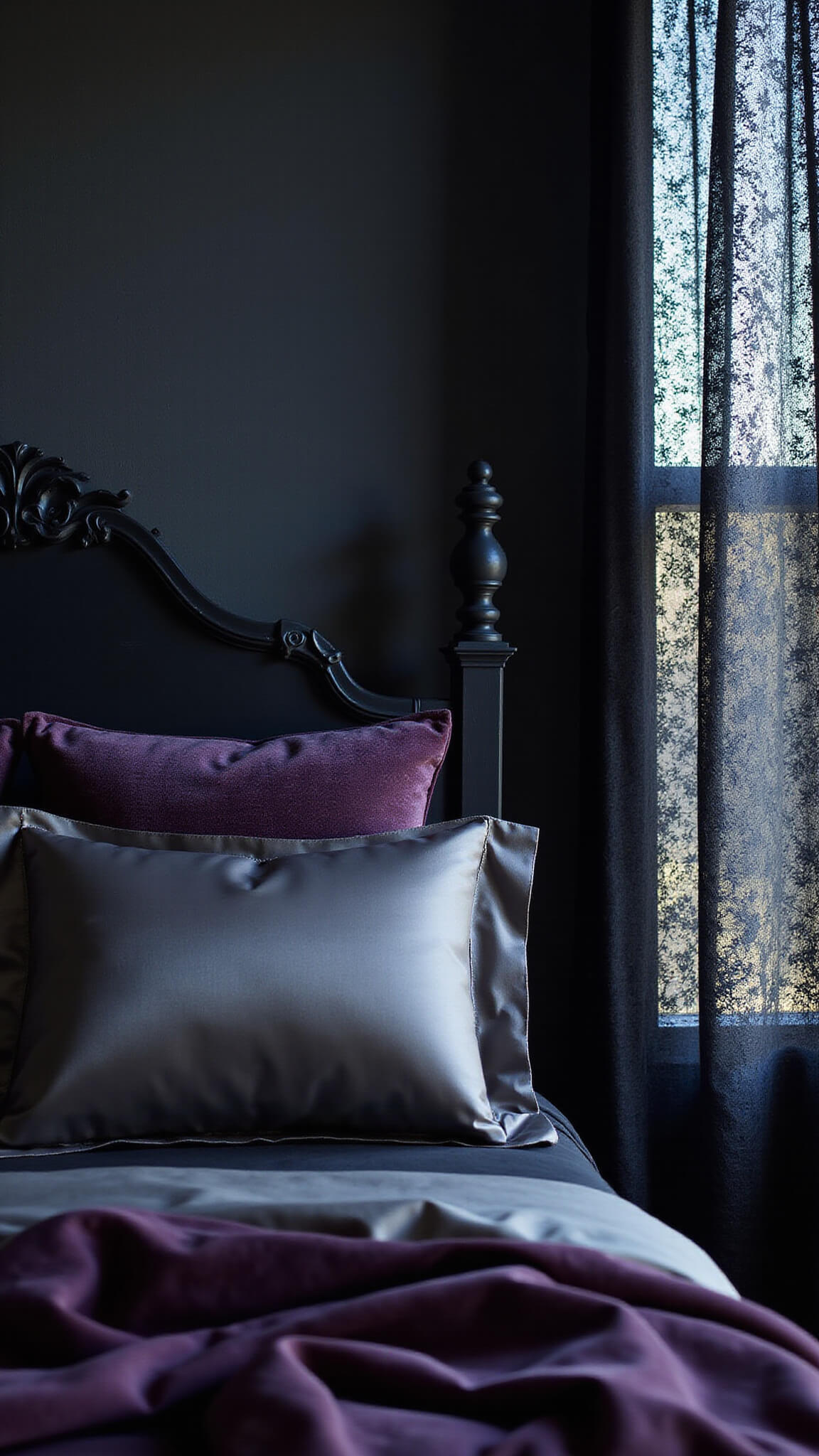 Twilight bedroom with black silk sheets, purple velvet quilt, silver damask pillows, and lace curtains casting soft patterns.