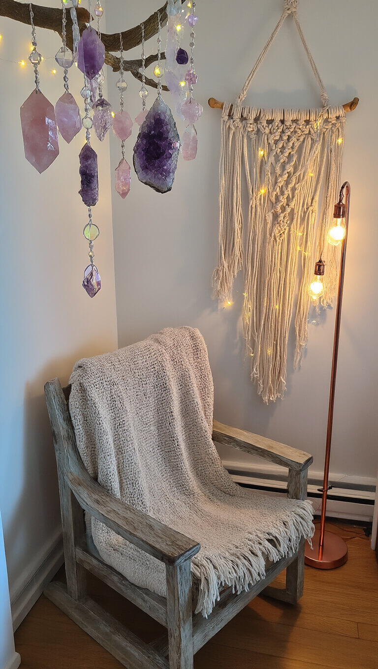 Cozy bedroom corner with oak reading chair under hanging crystals, lit by LED fairy lights and copper floor lamp, macramé wall art with rose quartz and amethyst.