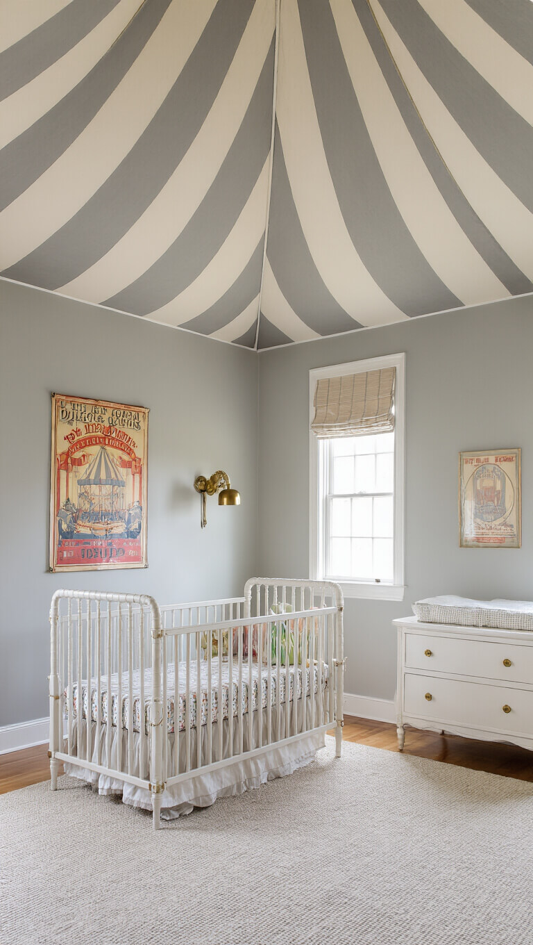 Eye-level view of a 12x12ft Dumbo-themed nursery with circus-striped ceiling, pale gray walls, vintage circus posters, and white furniture with brass accents in soft morning light.